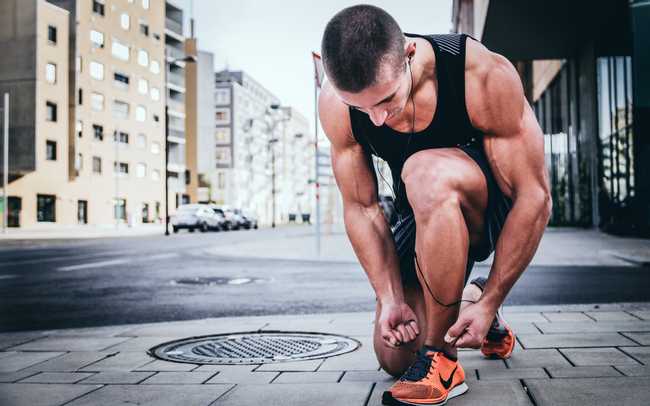 Man tying shoes before a run